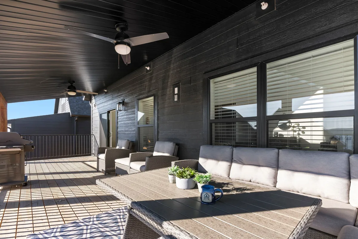 A welcoming outdoor seating area featuring a dining table and grill, inviting guests to relax, dine, and socialize in a comfortable setting. Surrounded by natural beauty, this space is ideal for morning coffee or evening barbecues, all under the open sky.