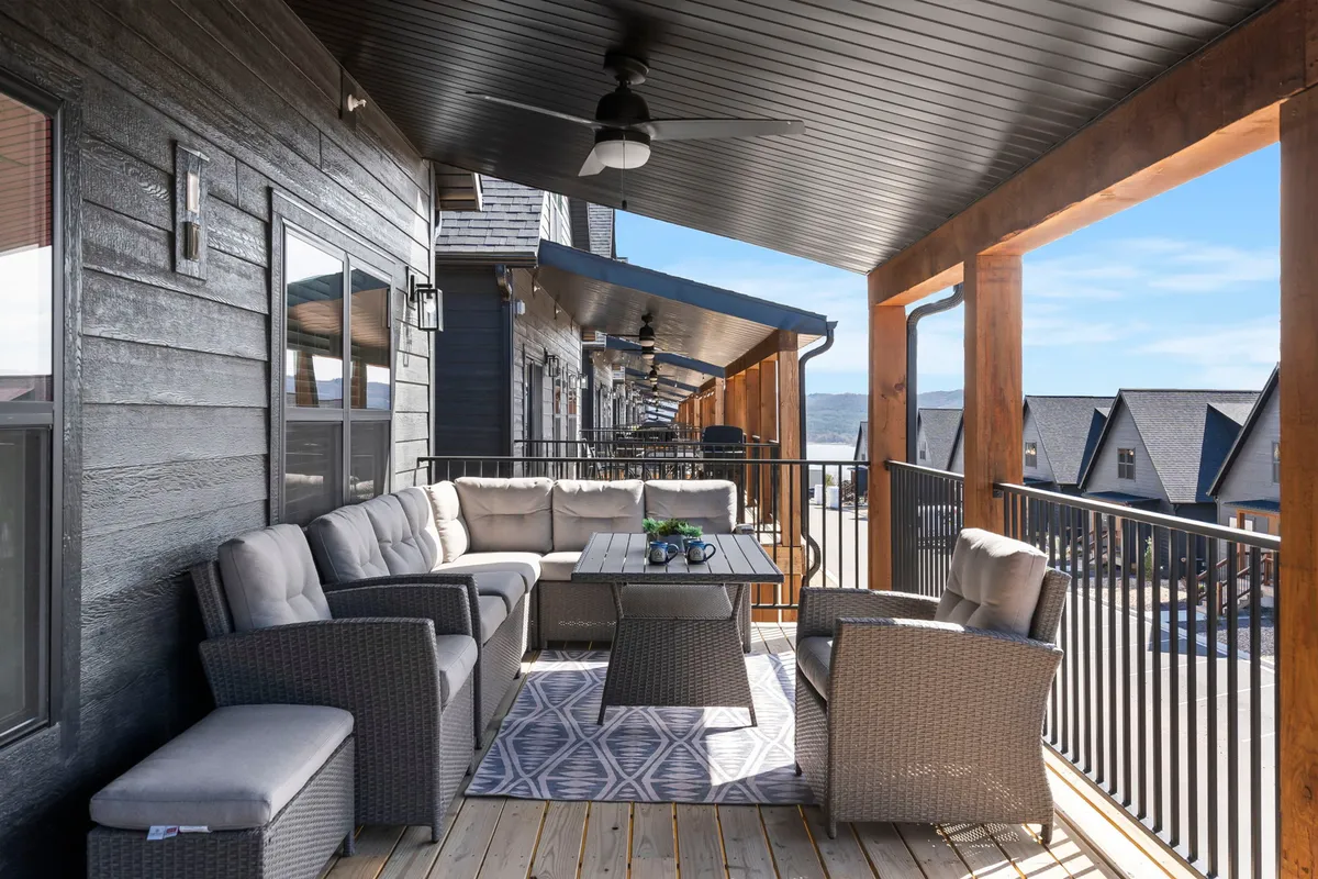 A cozy and comfortable exterior seating area with an outdoor table and a view of the surrounding landscape. The space is ideal for sharing stories, unwinding after a day of activities, or stargazing with friends and family.